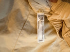 Eileen Fisher cream pants fabric care tag showing 66 percent organic cotton, 32 percent hemp, 2 percent elastane